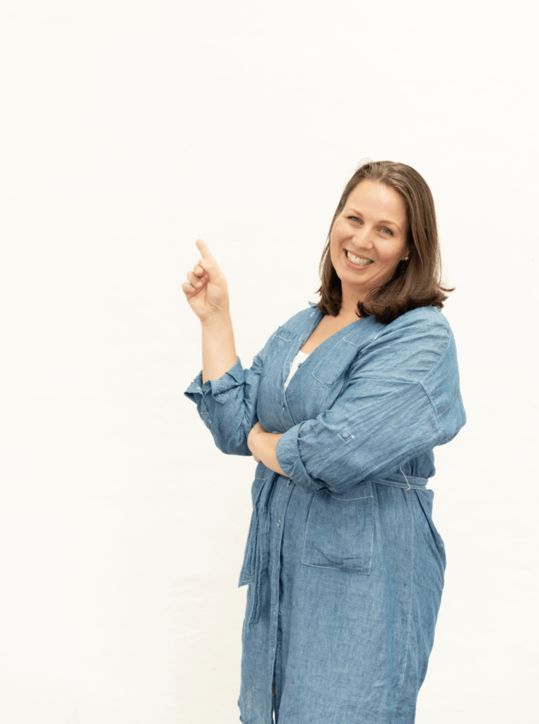 lucy rucinska founder of porada advisory in blue dress pointing above (1)